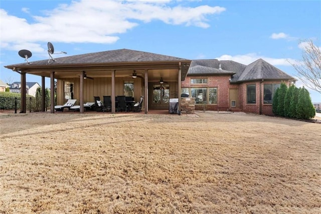 rear view of property featuring ceiling fan