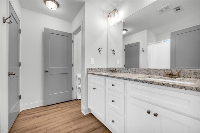 bathroom with vanity, curtained shower, and hardwood / wood-style floors