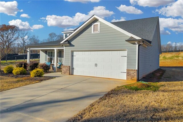 view of front of property featuring a garage and a porch