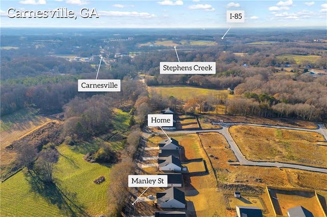 birds eye view of property with a rural view