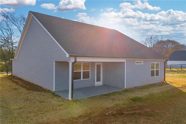 rear view of property with a patio area and a yard