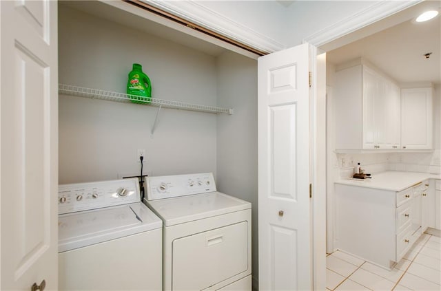 laundry room featuring light tile patterned flooring and washer and clothes dryer