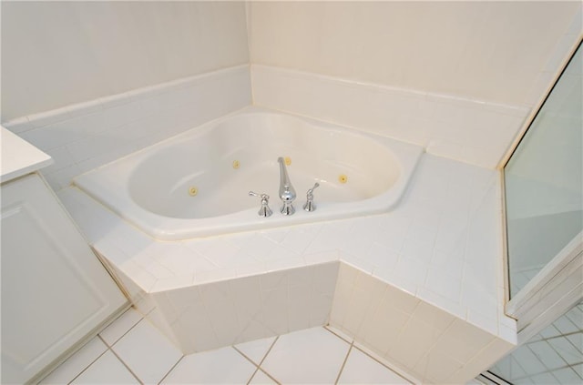 bathroom with vanity, tile patterned floors, and a relaxing tiled tub