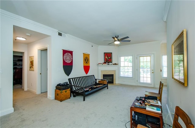 living room featuring carpet, ceiling fan, and ornamental molding