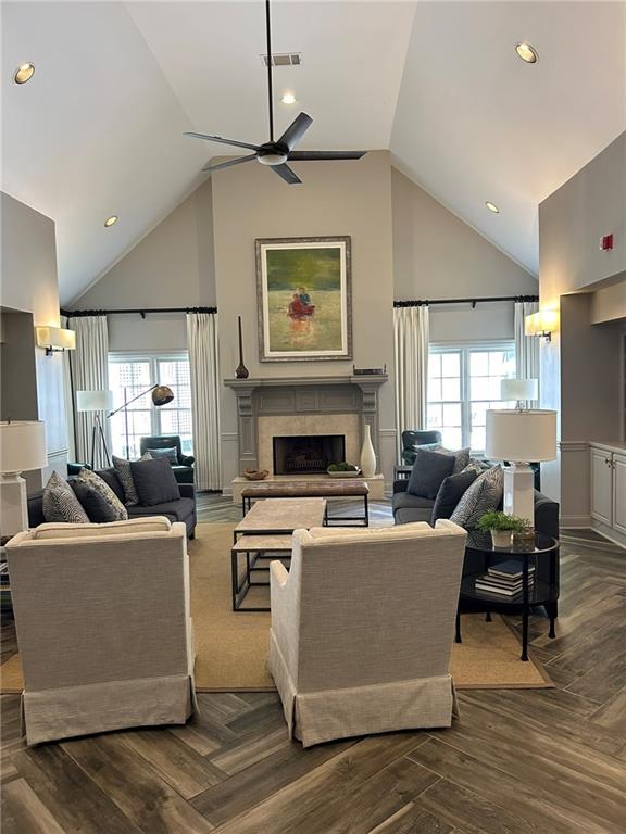 living room with high vaulted ceiling and ceiling fan