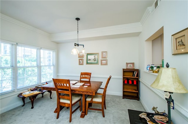 dining space with light carpet and ornamental molding