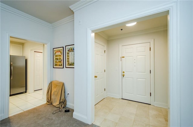 entryway with light tile patterned floors and ornamental molding