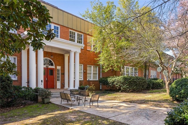 view of front of property with brick siding and board and batten siding