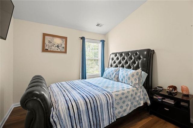 bedroom featuring dark wood-style floors, baseboards, and lofted ceiling