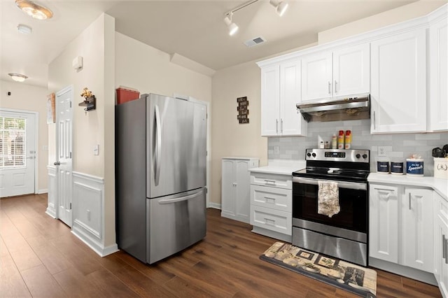 kitchen featuring appliances with stainless steel finishes, under cabinet range hood, light countertops, white cabinets, and dark wood finished floors
