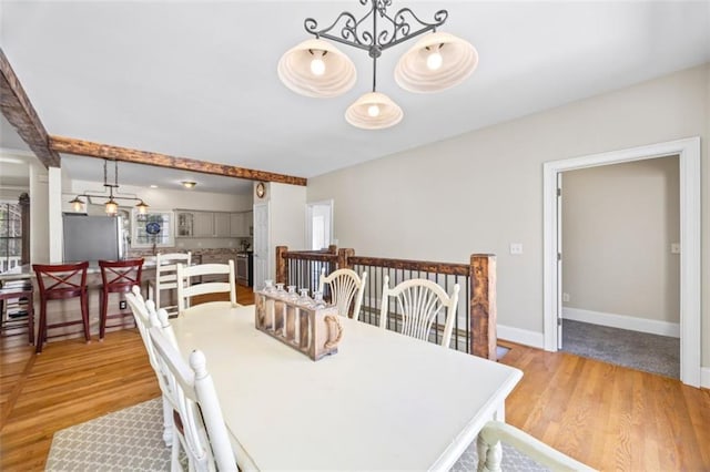 dining room with an inviting chandelier and light hardwood / wood-style floors