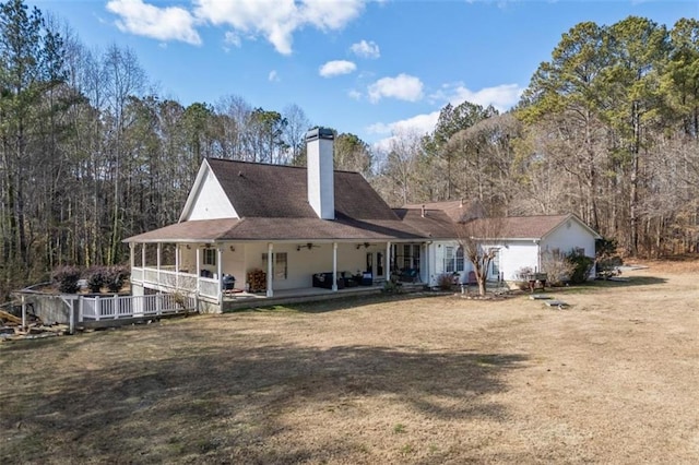 rear view of property featuring a yard