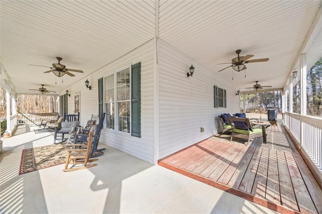 deck with ceiling fan and a porch