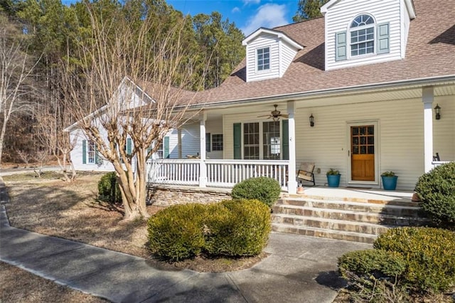 new england style home featuring ceiling fan and a porch