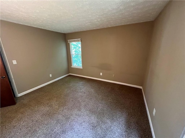 2705 Rhoanoke Dr, Duluth, GA 30096 - empty room featuring a textured ceiling, baseboards, and dark carpet