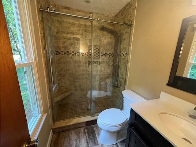 2705 Rhoanoke Dr, Duluth, GA 30096 - bathroom featuring plenty of natural light, a stall shower, toilet, and wood finished floors