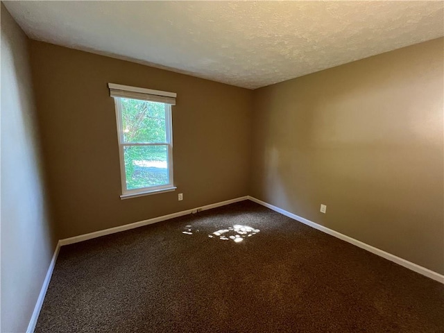 2705 Rhoanoke Dr, Duluth, GA 30096 - spare room with baseboards, dark colored carpet, and a textured ceiling