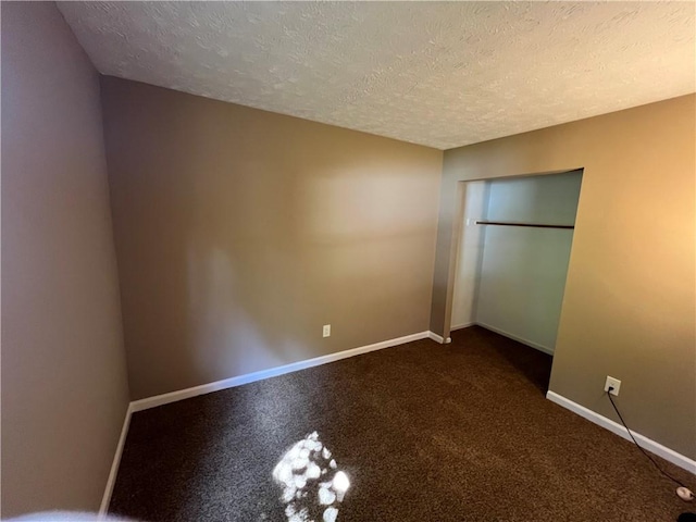 2705 Rhoanoke Dr, Duluth, GA 30096 - unfurnished bedroom featuring baseboards, a closet, carpet flooring, and a textured ceiling