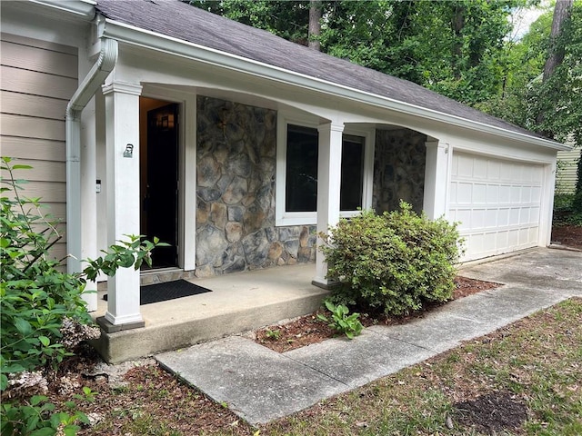 2705 Rhoanoke Dr, Duluth, GA 30096 - view of exterior entry with roof with shingles, an attached garage, a porch, and stone siding