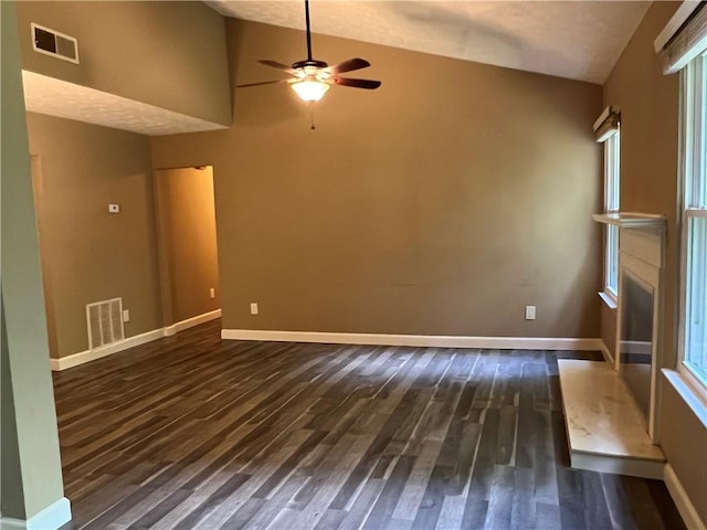 2705 Rhoanoke Dr, Duluth, GA 30096 - unfurnished living room with a ceiling fan, vaulted ceiling, visible vents, and dark wood-type flooring