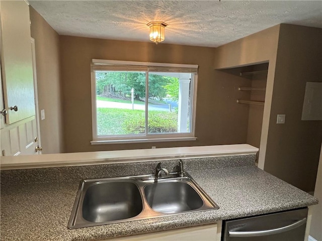 2705 Rhoanoke Dr, Duluth, GA 30096 - kitchen with a sink, stainless steel dishwasher, a textured ceiling, and white cabinetry
