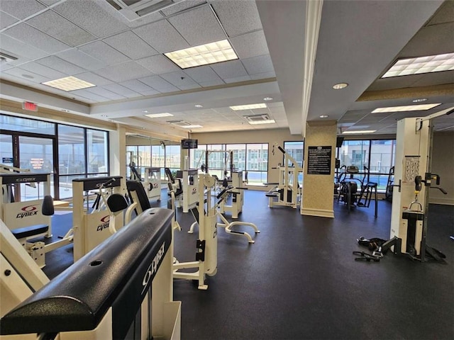 gym with a paneled ceiling