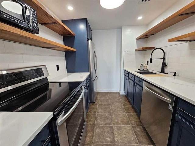 kitchen featuring stainless steel appliances, blue cabinets, sink, and decorative backsplash