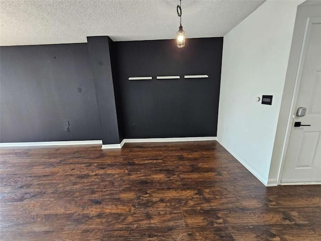 interior space featuring dark wood-type flooring and a textured ceiling