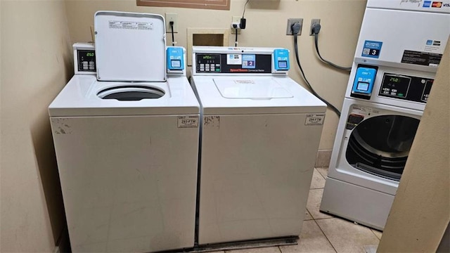 laundry room with washing machine and dryer and light tile patterned floors