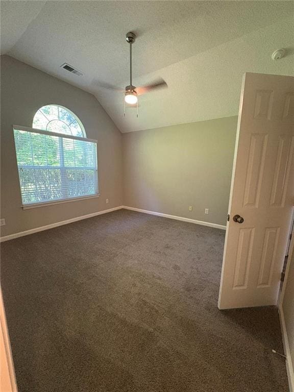 12 Barrington Ct, Sharpsburg, GA 30277 - spare room featuring vaulted ceiling, ceiling fan, dark carpet, and a textured ceiling