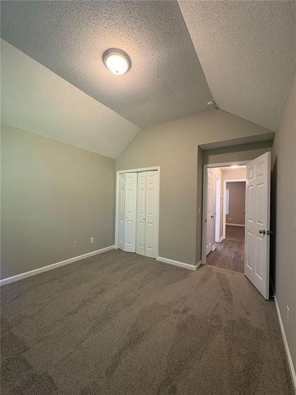 12 Barrington Ct, Sharpsburg, GA 30277 - unfurnished bedroom with lofted ceiling, carpet flooring, a textured ceiling, and a closet