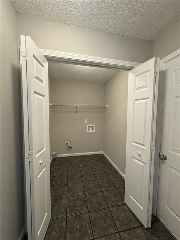 12 Barrington Ct, Sharpsburg, GA 30277 - laundry area with hookup for a washing machine, dark tile patterned flooring, and a textured ceiling