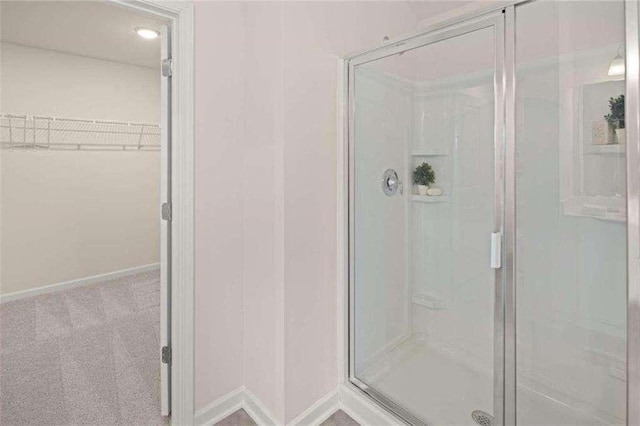 3064 Steinbeck Way, Atlanta, GA 30344 - full bath featuring a shower stall, a walk in closet, and baseboards