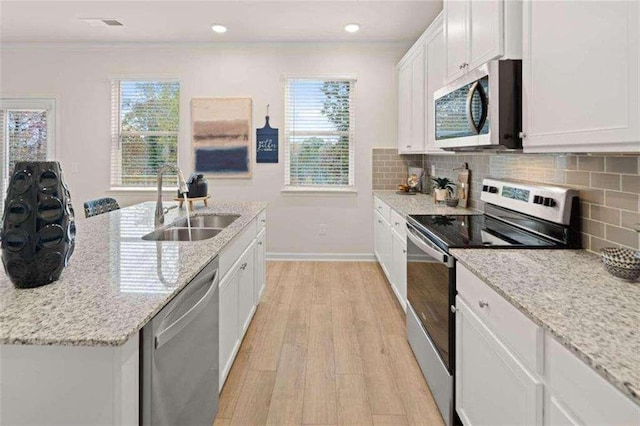 3064 Steinbeck Way, Atlanta, GA 30344 - kitchen with stainless steel appliances, a sink, light wood-style floors, baseboards, and white cabinetry