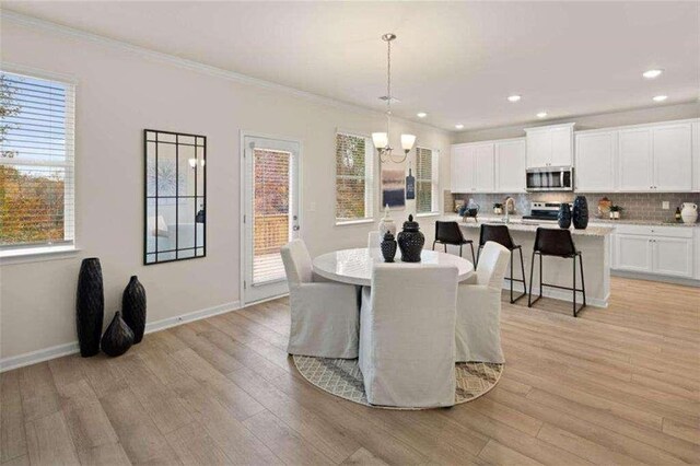 3064 Steinbeck Way, Atlanta, GA 30344 - dining space with a chandelier, light wood finished floors, ornamental molding, baseboards, and recessed lighting