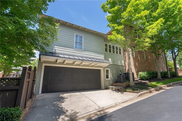175 Centennial Trce, Roswell, GA 30076 - view of front of house featuring a garage, driveway, a standing seam roof, and a metal roof