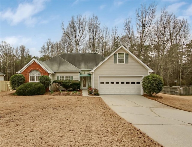 traditional home featuring driveway, an attached garage, and brick siding