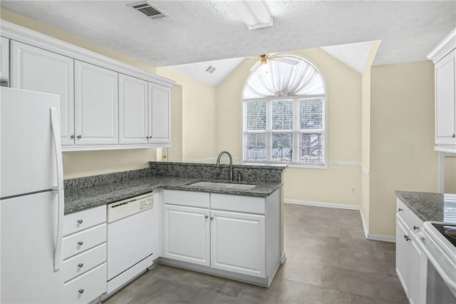 kitchen featuring white appliances, visible vents, white cabinets, and a sink