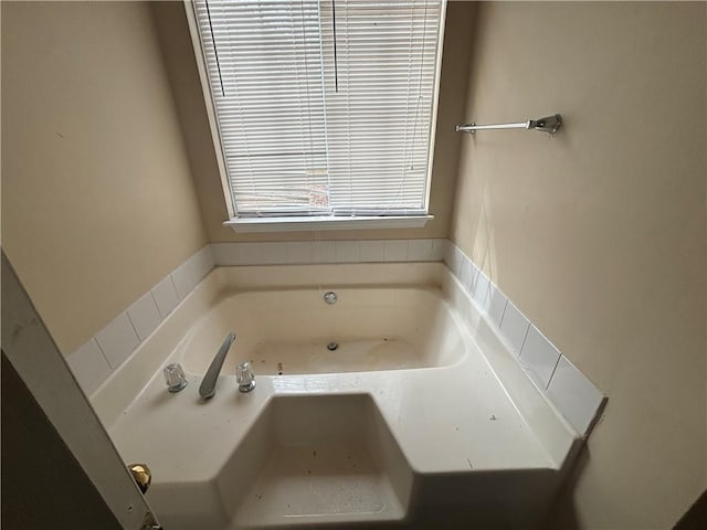 bathroom featuring a tub to relax in