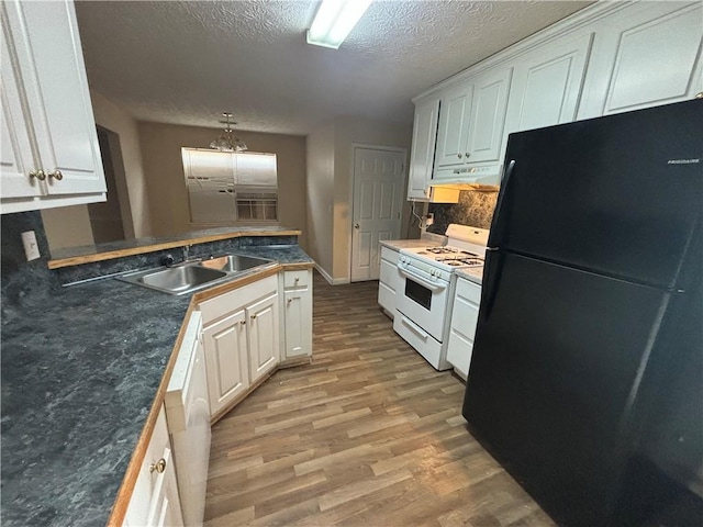 kitchen featuring white cabinetry and white appliances