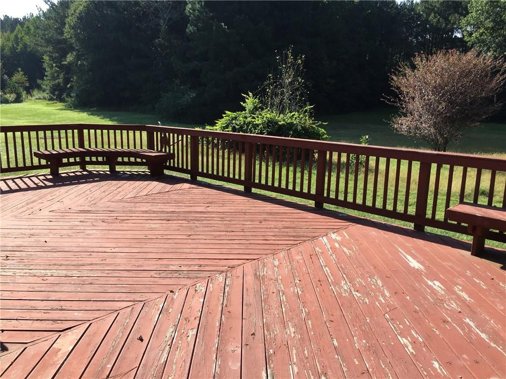 wooden terrace with a lawn