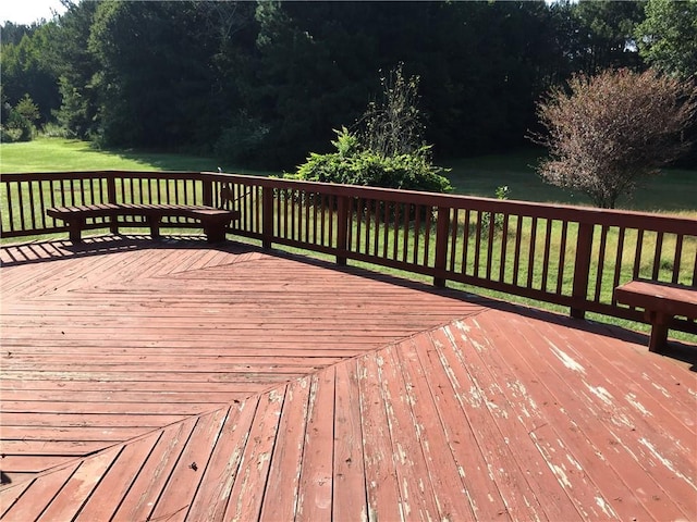 wooden terrace with a lawn