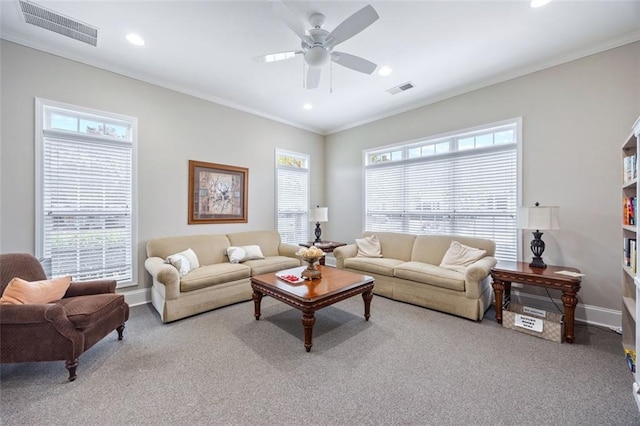 living room featuring plenty of natural light, ceiling fan, and crown molding