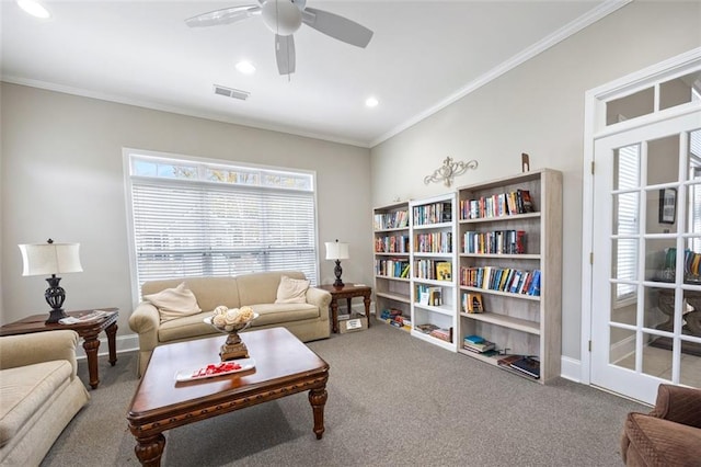 living room with ceiling fan, crown molding, and carpet floors