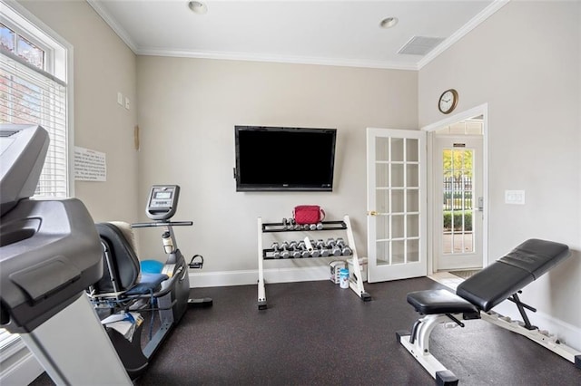 exercise area featuring crown molding