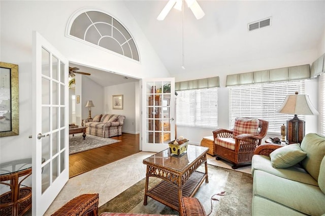 sunroom with ceiling fan, french doors, and lofted ceiling