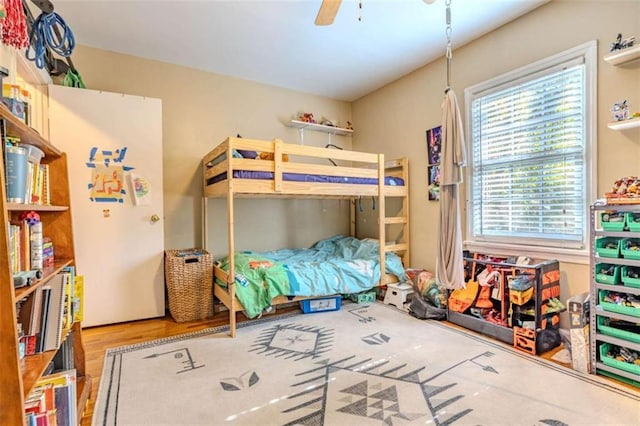 bedroom featuring wood-type flooring and ceiling fan