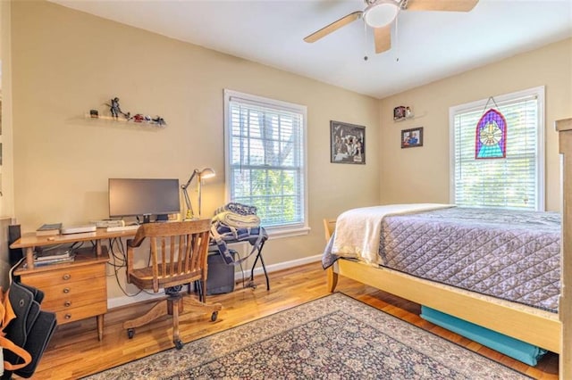 bedroom with multiple windows and wood-type flooring