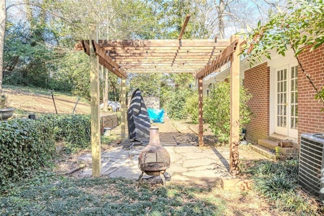 view of patio / terrace with a pergola, a fire pit, french doors, and central air condition unit