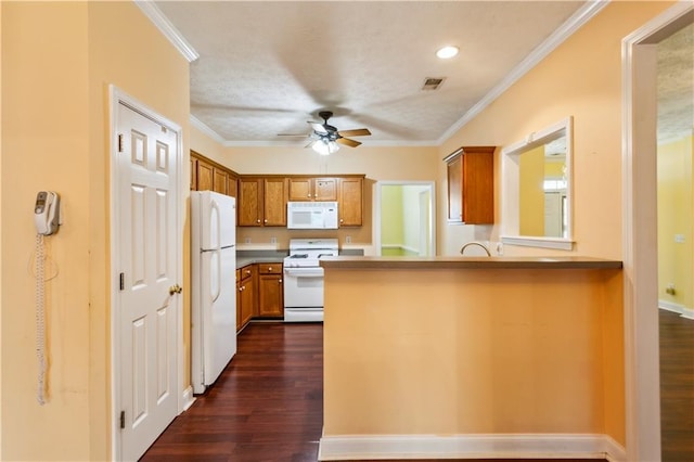 99 Rainwater Ln, Dallas, GA 30157 - kitchen featuring white appliances, a ceiling fan, dark wood-type flooring, brown cabinetry, and a peninsula